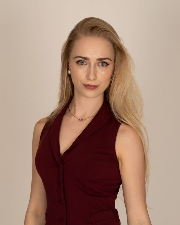 Maureen Evelyn, relationship coach, in a burgundy vest